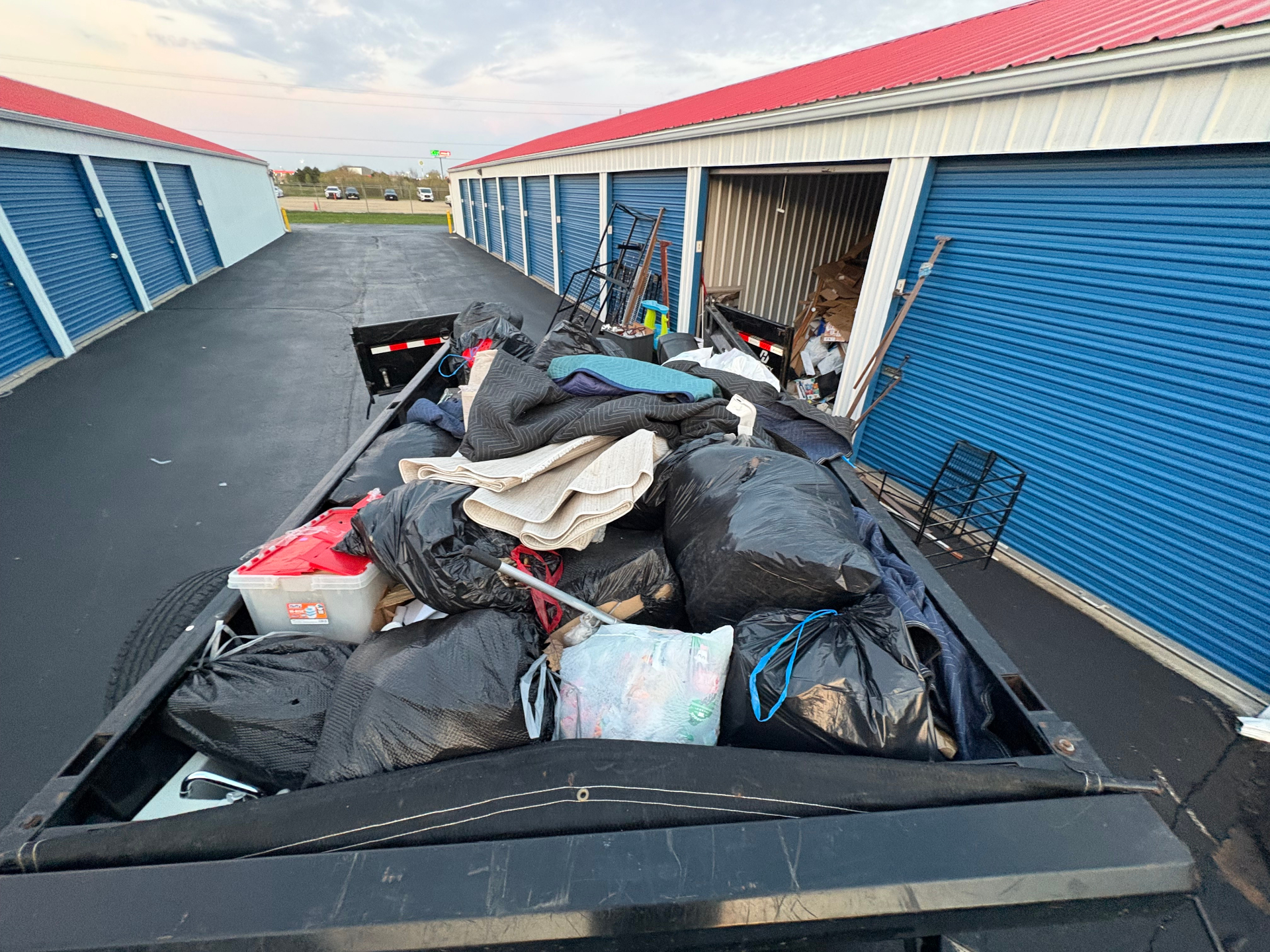 TrashDash dump trailer fully loaded with bagged contents from a storage unit cleanout in Peoria, IL — an Estate Cleanout Peoria IL job.