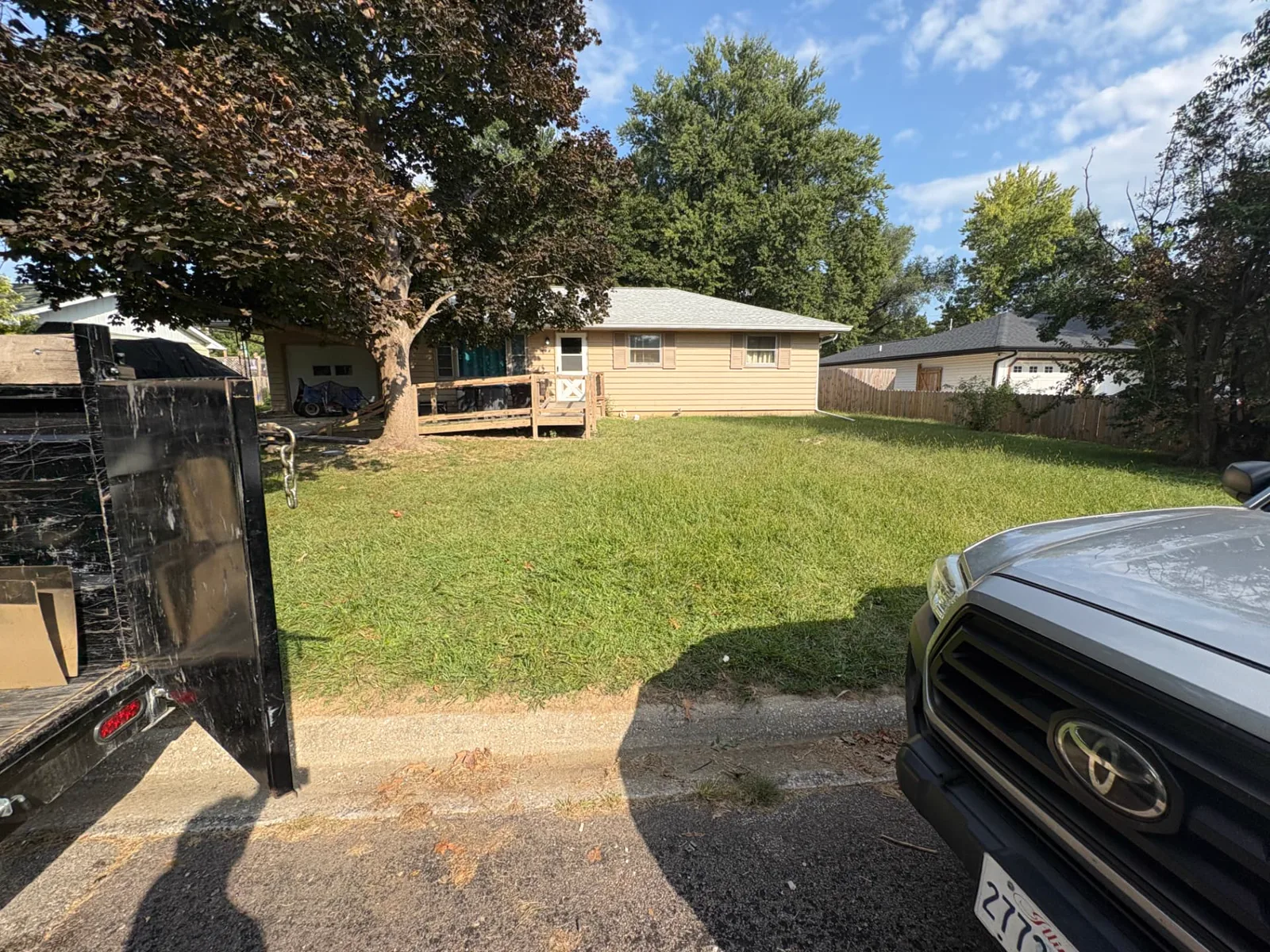 Cleared residential curb after TrashDash removed household items and debris