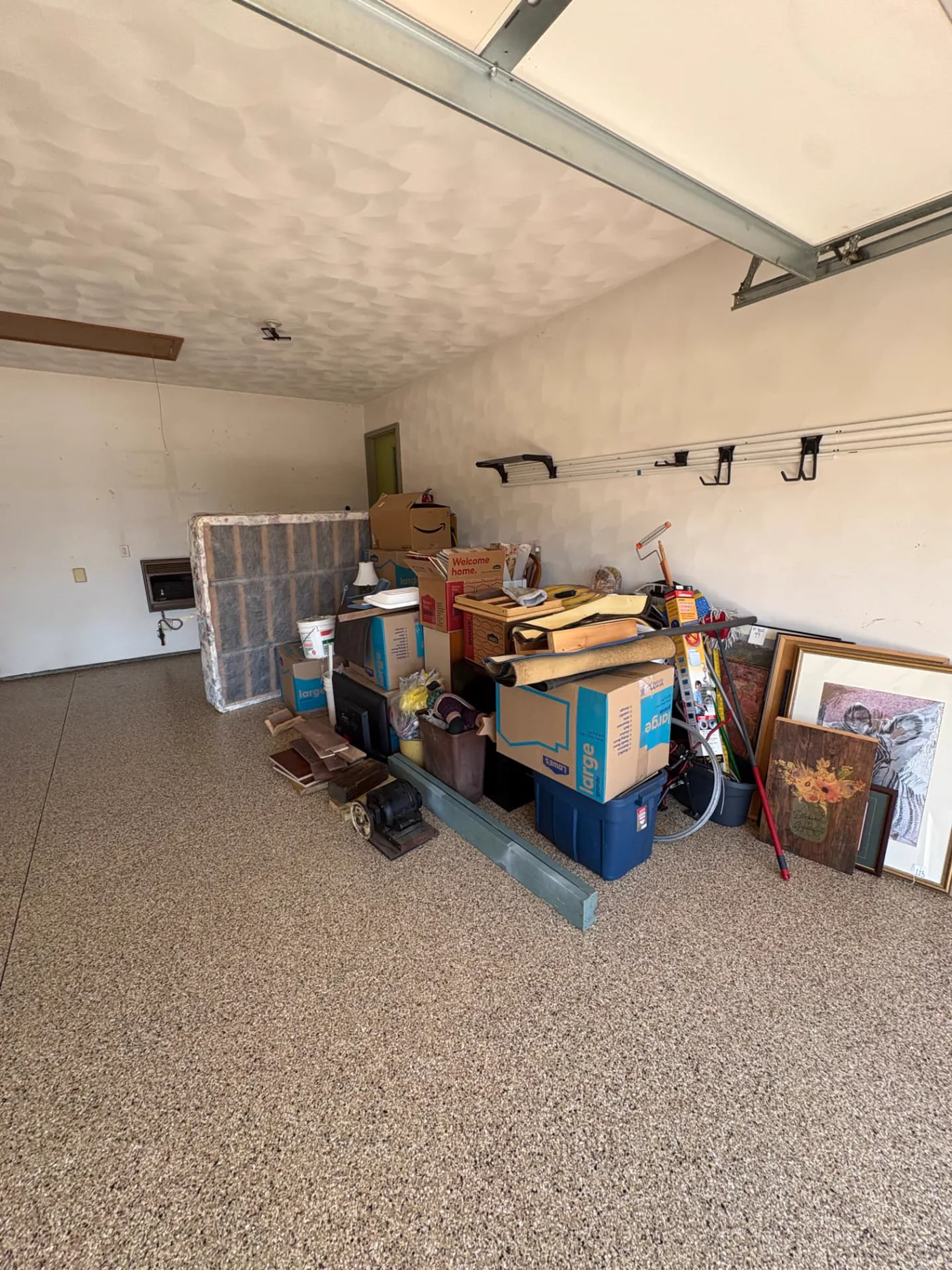 Residential garage pickup before removal Household items gathered inside a garage before TrashDash pickup